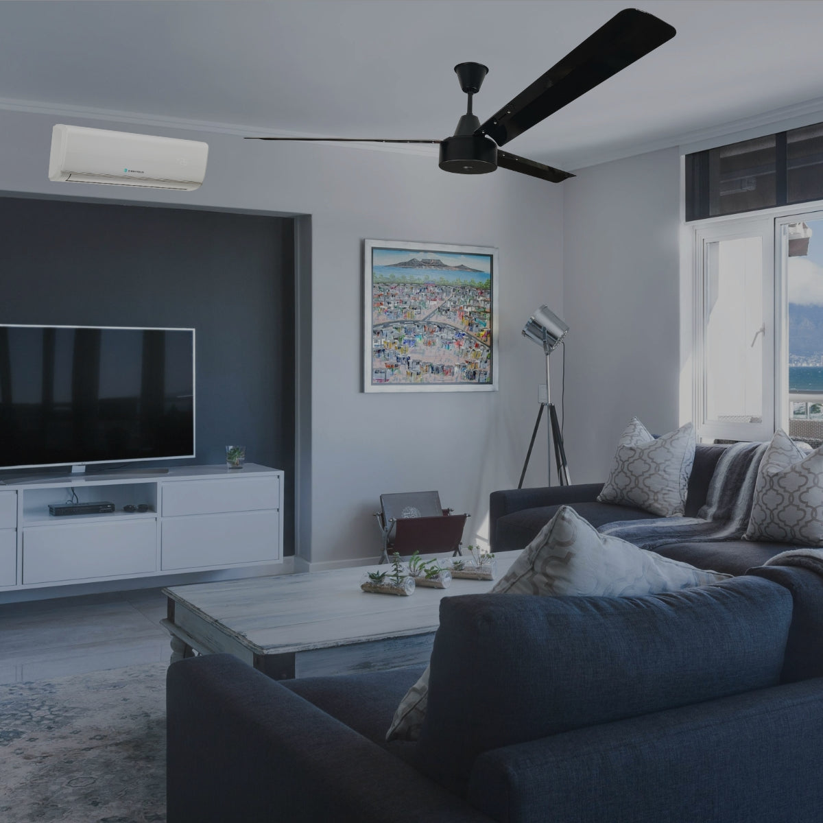 Stylish living room with ceiling fan and wall mounted air conditioner providing cooling and ventilation for home comfort.