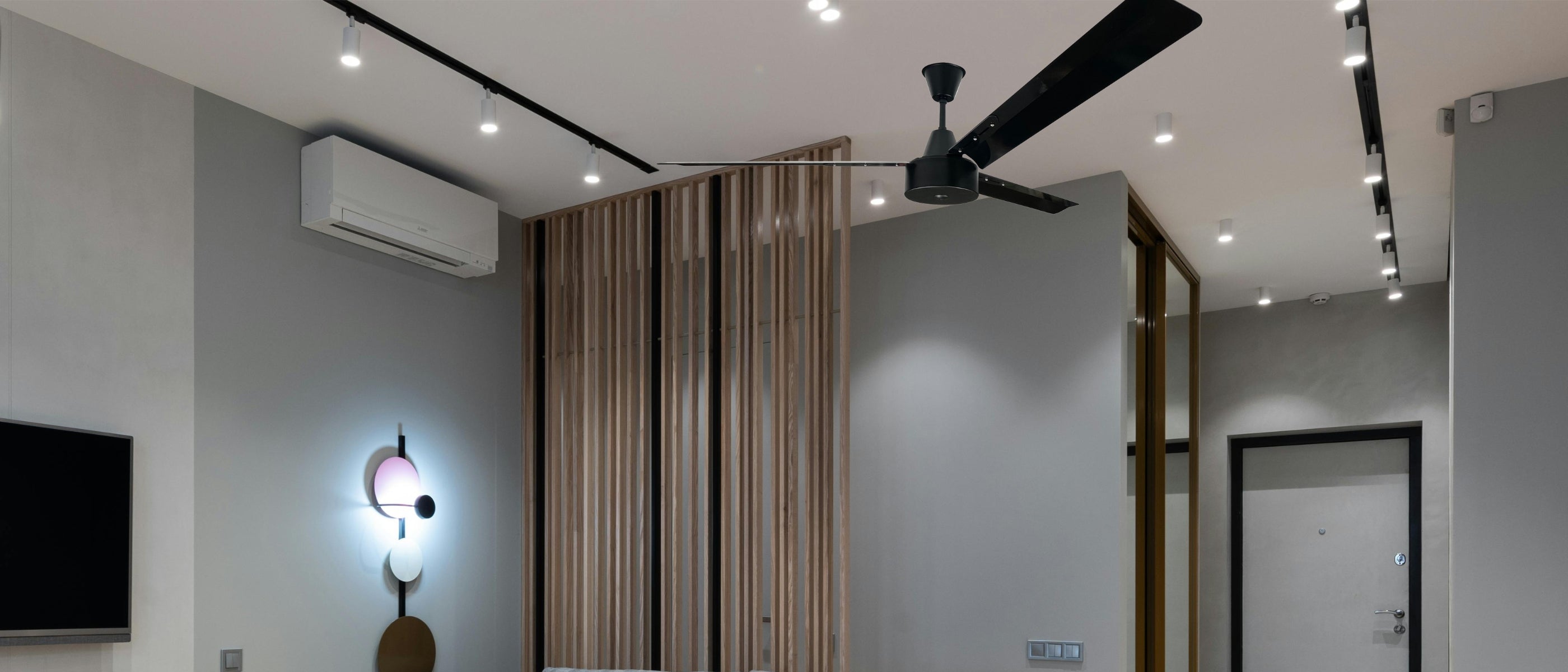 Stylish living room with a slimline inverter split air conditioner and a 1.65m black industrial ceiling fan for efficient cooling and comfort.