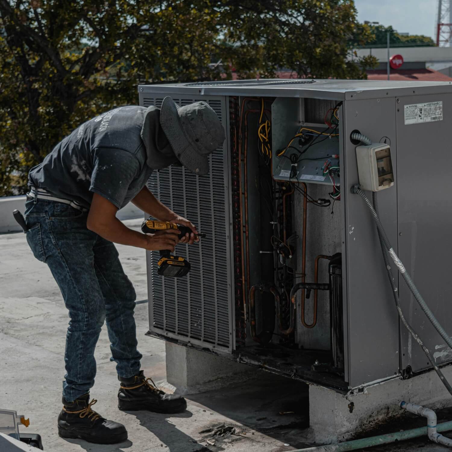 HVAC repair man representing air conditioning systems running on natural refrigerants lasting longer than HVAC systems using synthetic or chemical refrigerants ability to last long due to reduced wear and tear